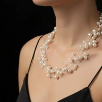 Multi-strand pearl necklace on a black background