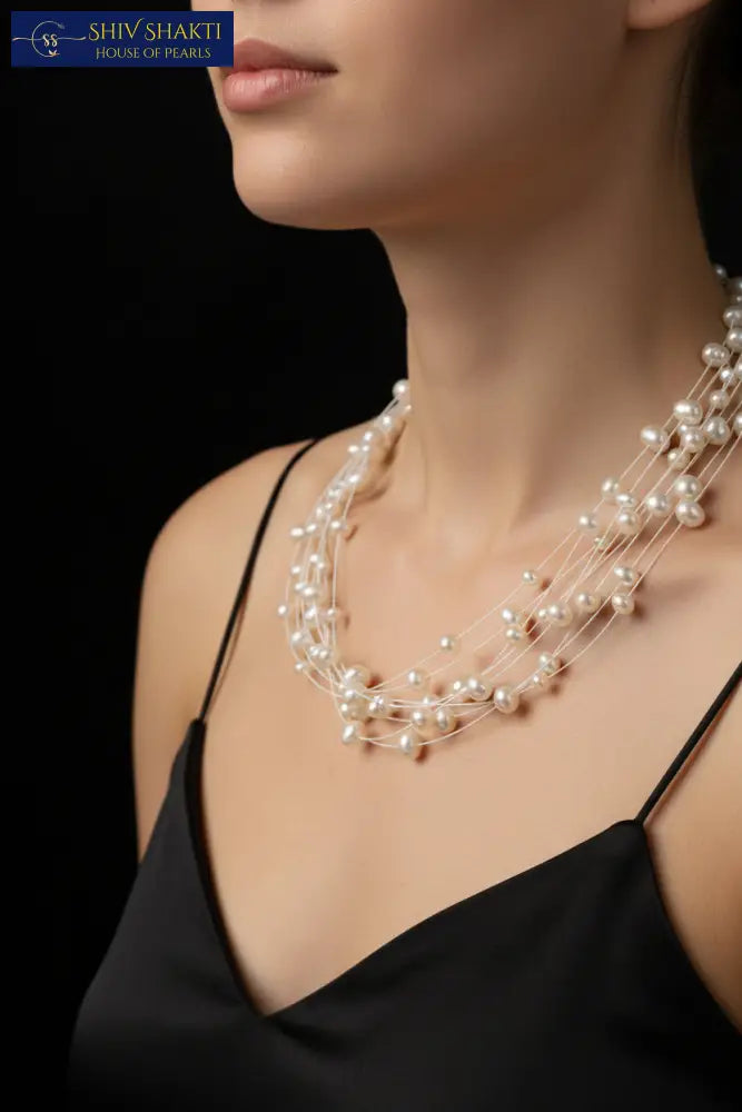 Multi-strand pearl necklace on a black background