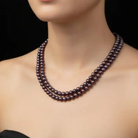 Pearl necklace on a black mannequin with a dark background