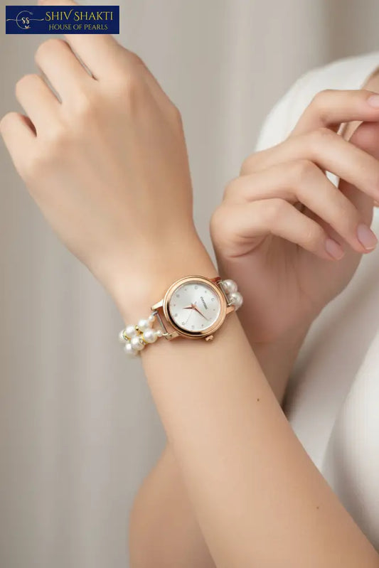 Wristwatch with pearl bracelet on a black background