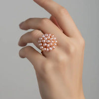 Pink pearl-like bead cluster on a black background