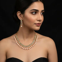 Pearl necklace and earrings on a black background