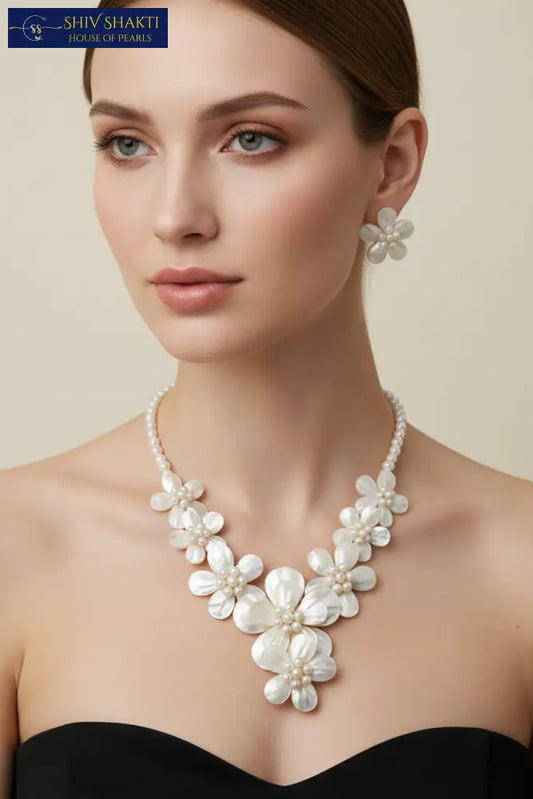 Pearl necklace and earrings on a black background